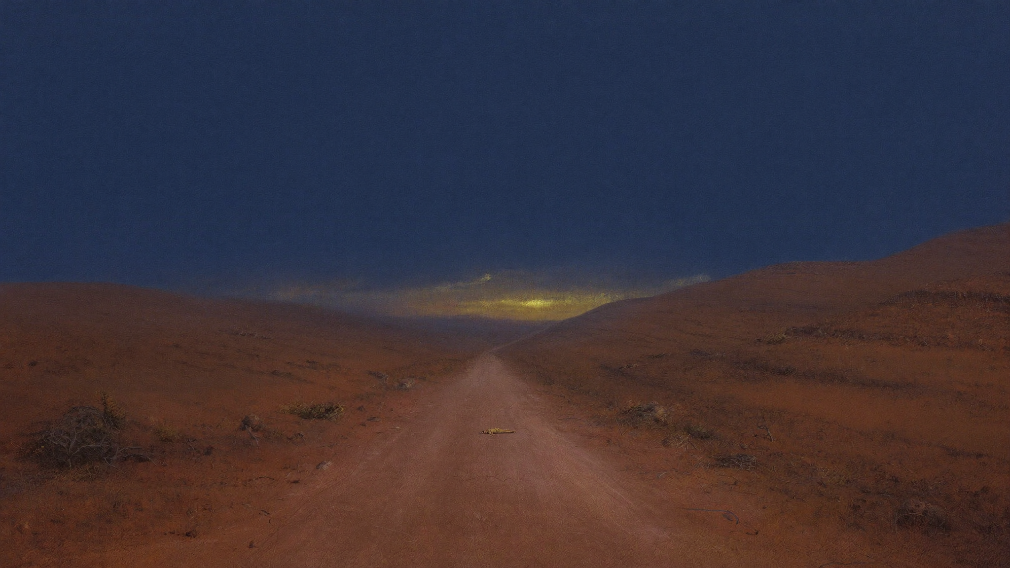 A long, lonely road winding down through dry hills, a small figure lying still at the roadside.