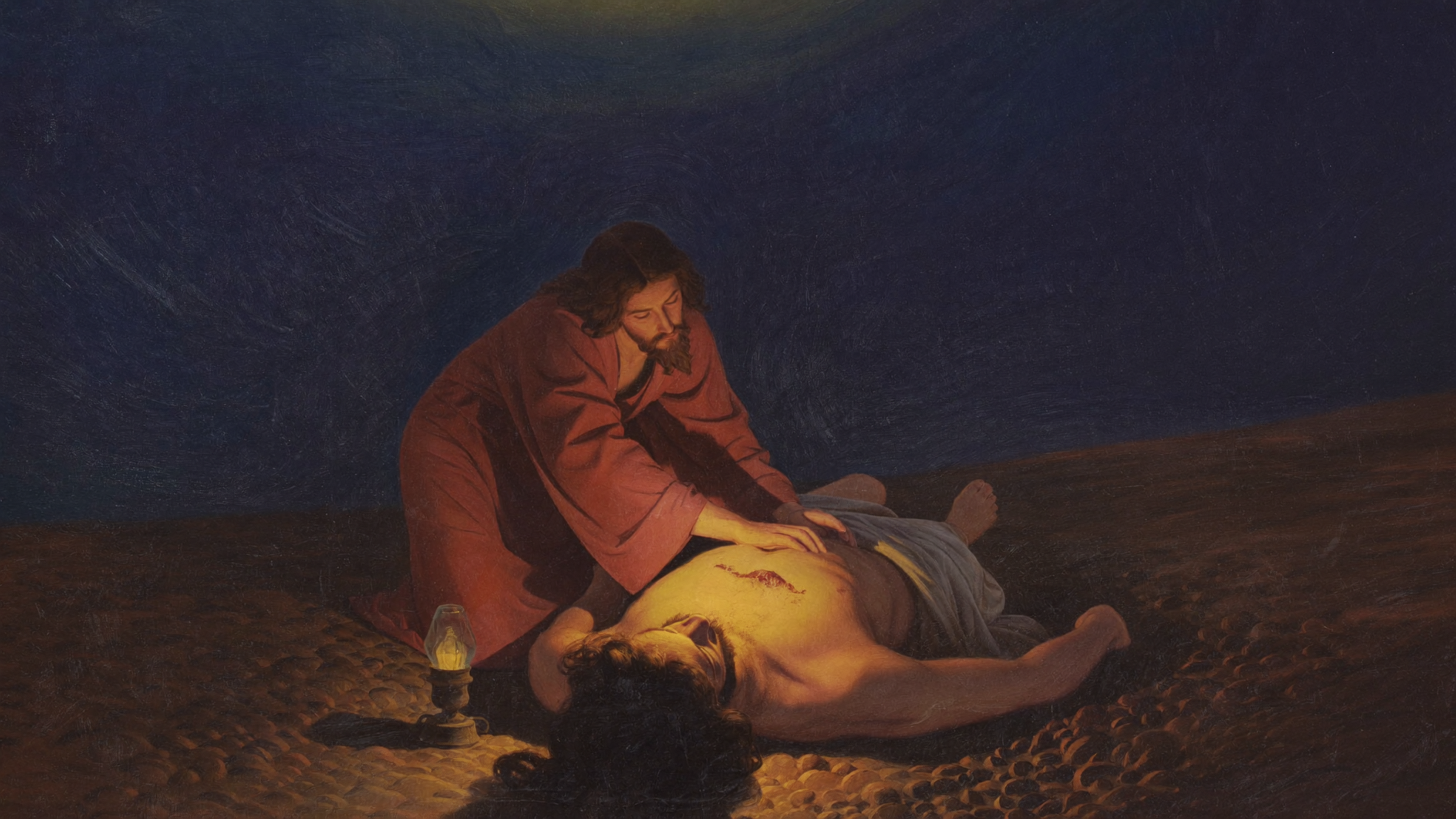 A figure kneeling in the dirt beside a wounded stranger, tending his wounds by warm lamplight.