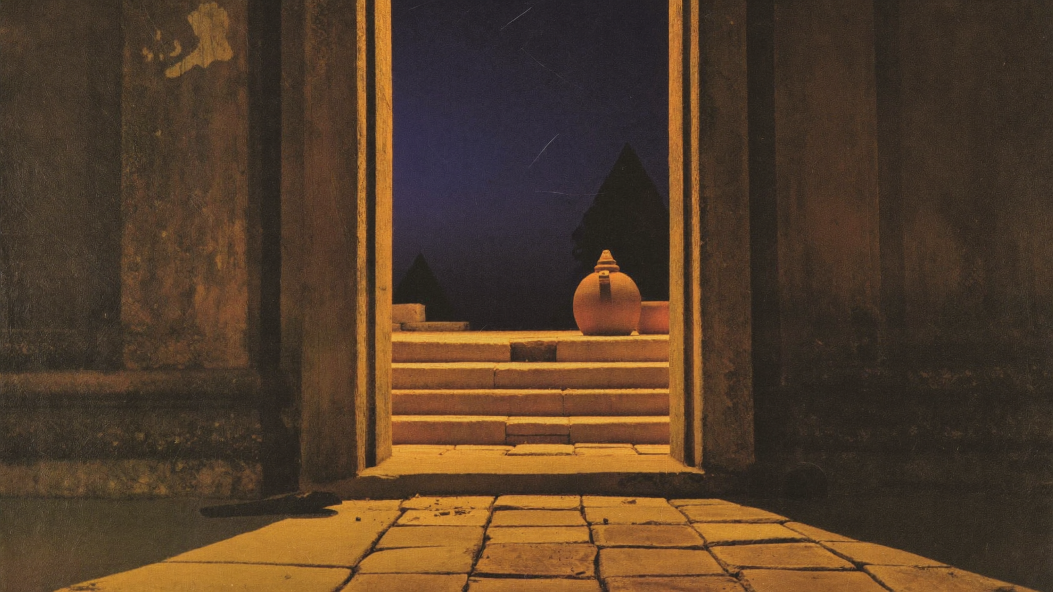 An open temple doorway with warm light spilling out onto empty steps at dusk