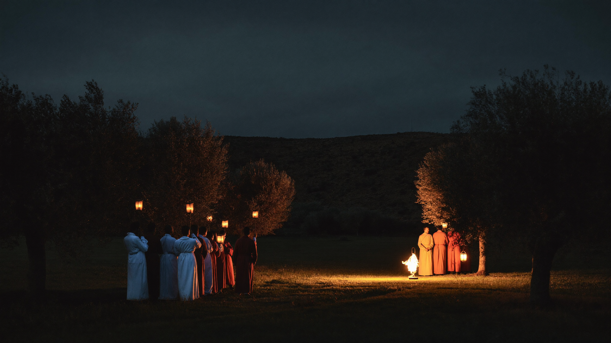 A torchlit night garden where a hand reaches to heal a wounded man as a drawn sword is lowered, warm gold light against deep navy dark.